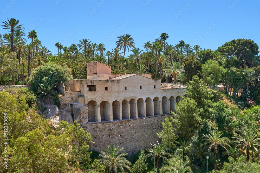 Molí del real with palm trees in the municipal park in Elche. Old 18th century mill. Located in Valencian community, Alicante,Elche, Spain.