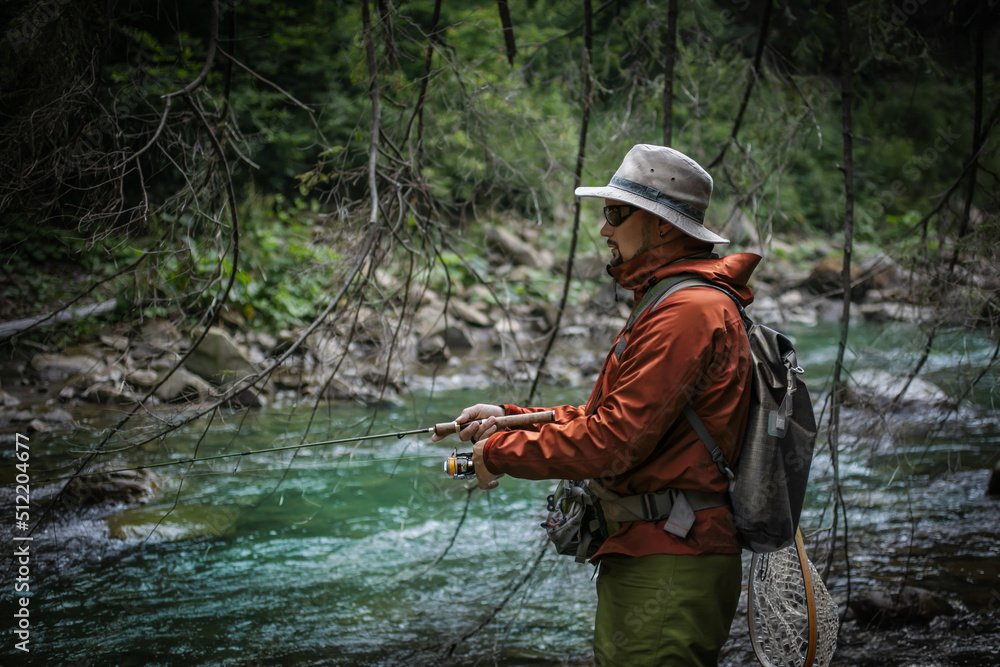 Fishing background. Fisherman catching trout on a river. Fishing background. Fisherman catching trout on a river.