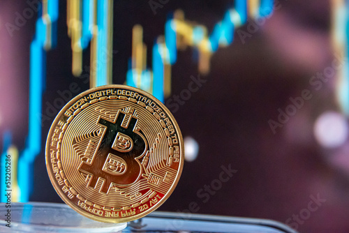 Close up golden Bitcoins mockup on tablet and stock chart background. Investment success Crypto currency Concept.