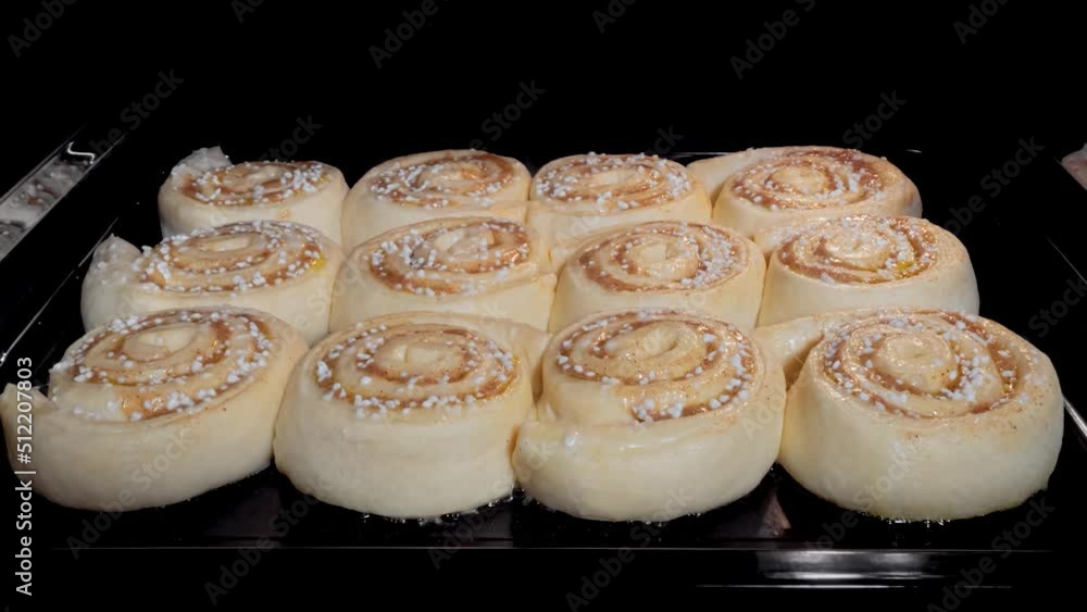 Timelapse - twelve cinnamon buns baking and rising on tray in electric oven at home - zoom in shot, close up front view. Homemade bakery, food, cooking, pastry and time lapse concept Timelapse - twelve cinnamon buns baking and rising on tray in electric oven at home - zoom in shot, close up front view. Homemade bakery, food, cooking, pastry and time lapse concept