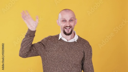 Hello gesture. Welcoming greeting. Boomerang animation. Saying hey. Friendly excited cheerful funny guy waving hand hi gif loop isolated on orange empty space background. photo