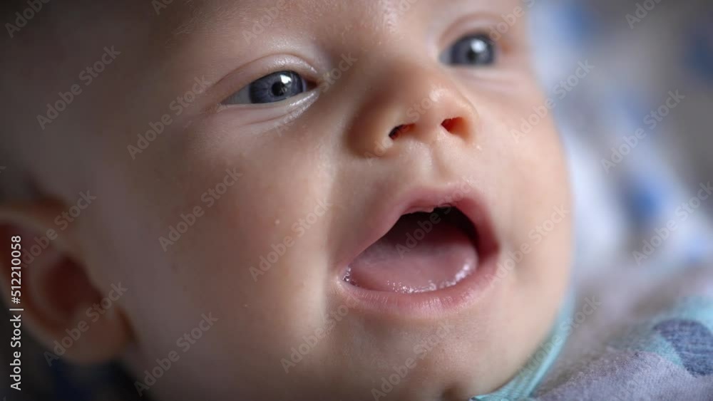 Small baby playing with parent and smiling in closeup Small baby playing with parent and smiling in closeup