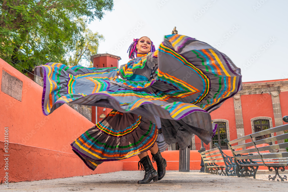 Young Mexican woman in a traditional folklore dress of many colors, traditional dancer. - obrazy, fototapety, plakaty 