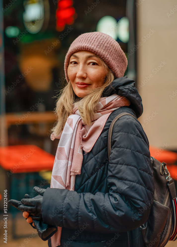 Asian woman in a black coat and hat walking around winter Europe city Asian woman in a black coat and hat walking around winter Europe city