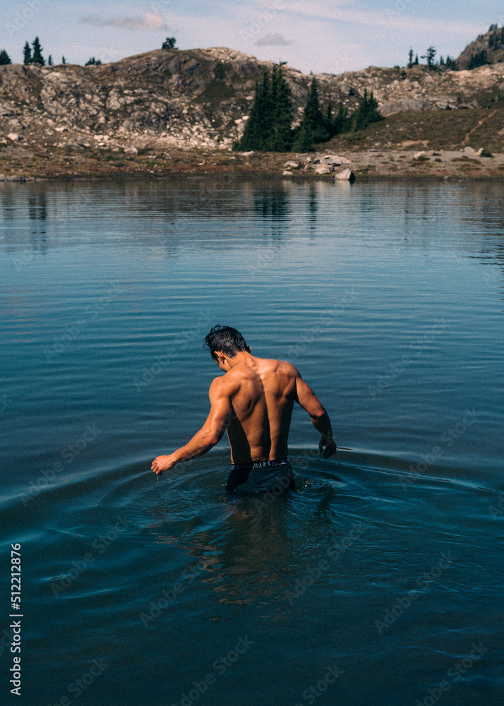 boy swimming in mountains