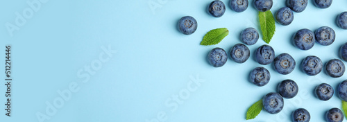 Tasty fresh blueberries on light blue background, flat lay with space for text. Banner design