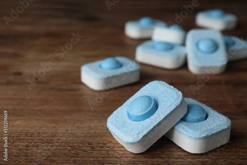 Water softener tablets on wooden table, closeup. Space for text