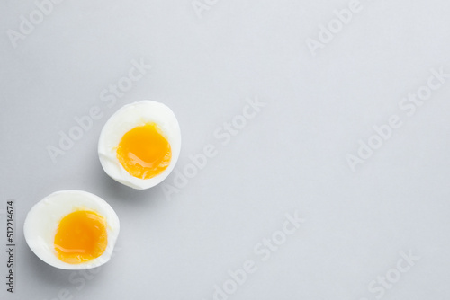 Obraz na płótnie Halves of fresh soft boiled egg on white background, flat lay