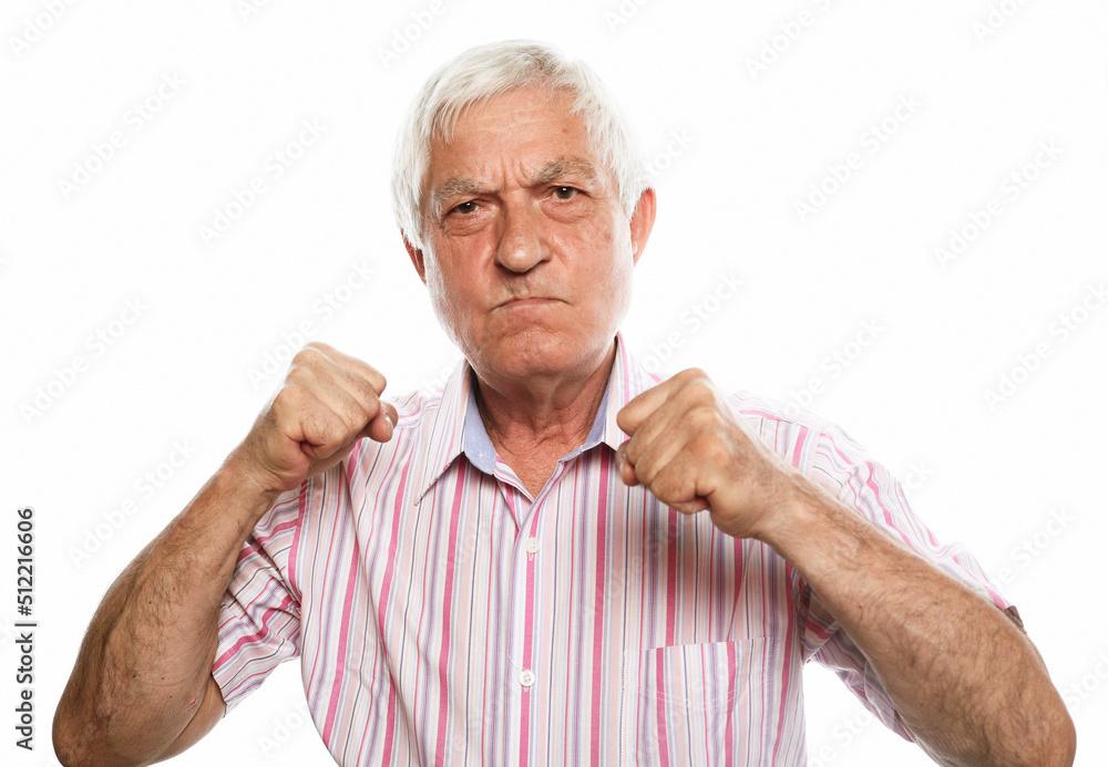 Emotion, old people and body language concept: Senior man looking unhappy and angry showing rejection and negative with clenched fists in anger gesture. Emotion, old people and body language concept: Senior man looking unhappy and angry showing rejection and negative with clenched fists in anger gesture.