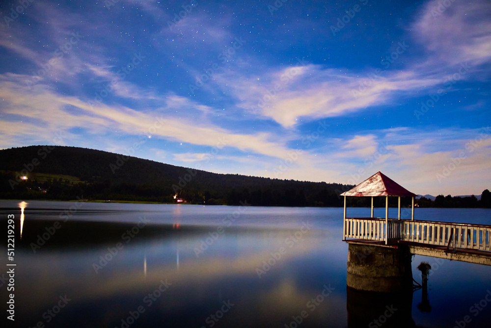 moonlight at lake in the evening with sky full of stars and dark forest in the background in the presa brockman el oro de hidalgo state of mexico