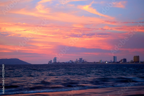 sea at sunset with mazatlan in the background with beautiful colors in the sky