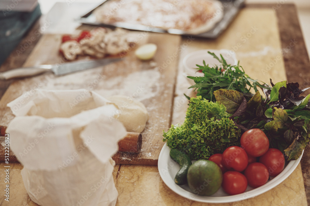 Vegetables spread out on the kitchen table flour mushrooms for cooking pizza at home Vegetables spread out on the kitchen table flour mushrooms for cooking pizza at home
