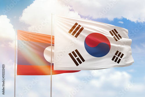 Sunny blue sky and flags of south korea and laos