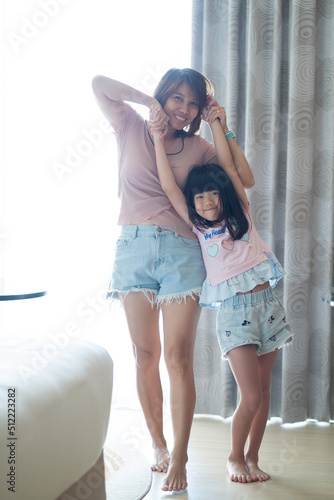 portrait asian kid with mother, child enjoy and happy, little girl