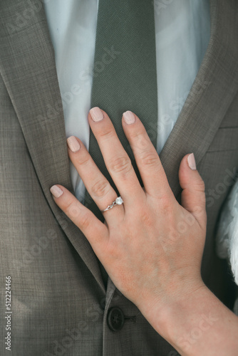 close up of the bride's hand on the groom © Allison
