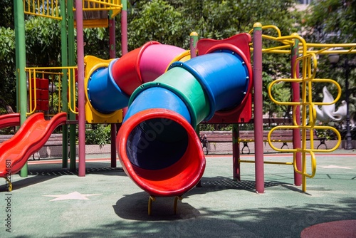 Colorful playground made of plastic empty outdoor playground set playground equipment. play area. Play area. Garden equipment. Children's slide. School yard. Playground in the park..