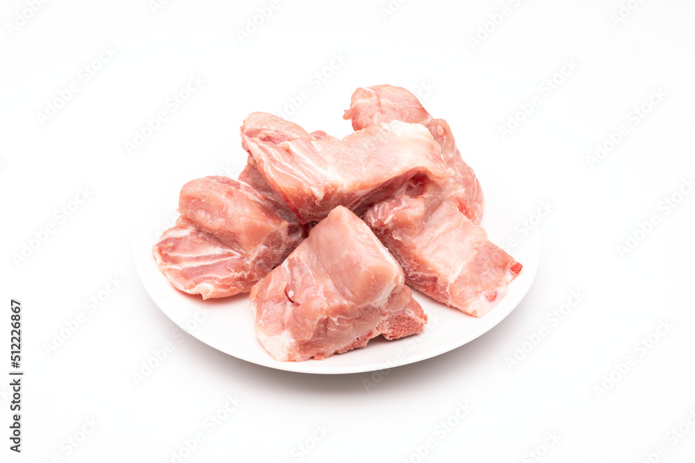 Raw Pork Bone Spine in white dish isolated on white Raw Pork Bone Spine in white dish isolated on white