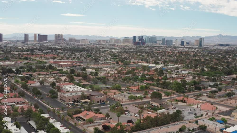 Aerial pullback shot Las Vegas residential houses with city skyline Aerial pullback shot Las Vegas residential houses with city skyline