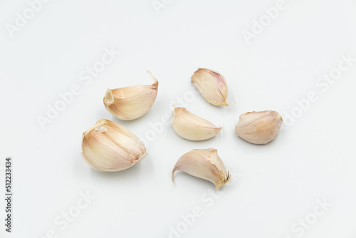 Isolated fresh raw garlic cloves on white background