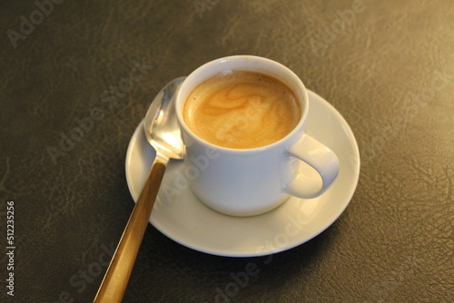 Cup of espresso with utensils