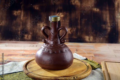 clay bottle, beautiful piece to store drinks on rustic wooden table