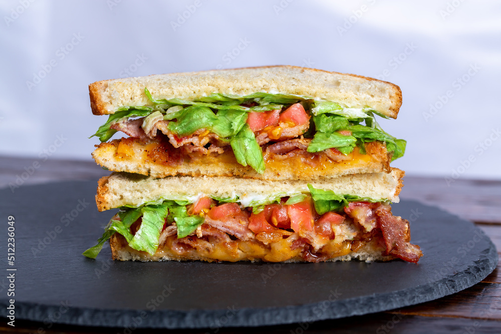 BLT Sandwich on White Bread laying on great slate tray BLT Sandwich on White Bread laying on great slate tray