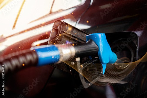 Car fueling at gas station. Refuel fill up with petrol gasoline. Petrol pump filling fuel nozzle in fuel tank of car at gas station. Petrol industry and service.