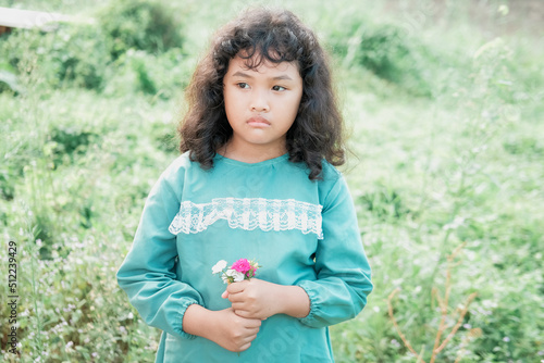 Portrait of a young Asian woman with curly hair with various facial expressions in the park in the morning