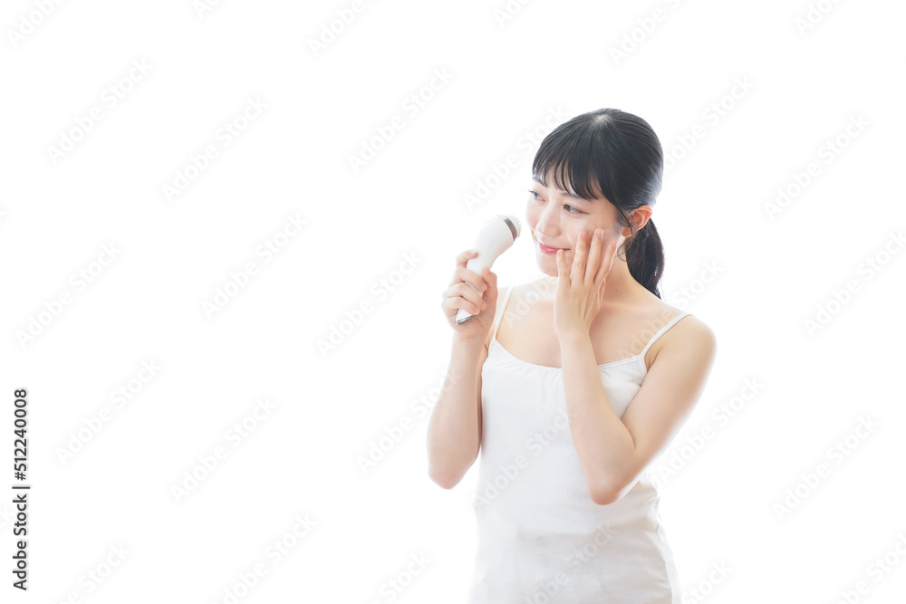 Young woman using a beauty equipment Young woman using a beauty equipment