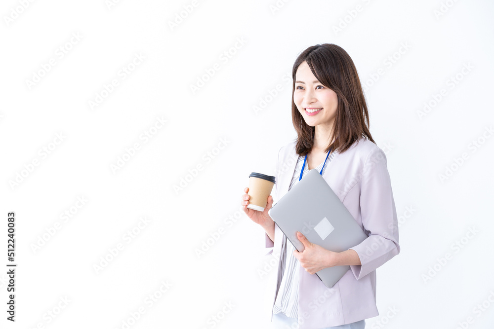 Beautiful businesswoman walking through the office with a cup of coffee Beautiful businesswoman walking through the office with a cup of coffee