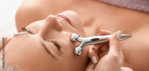 Mature woman receiving face...