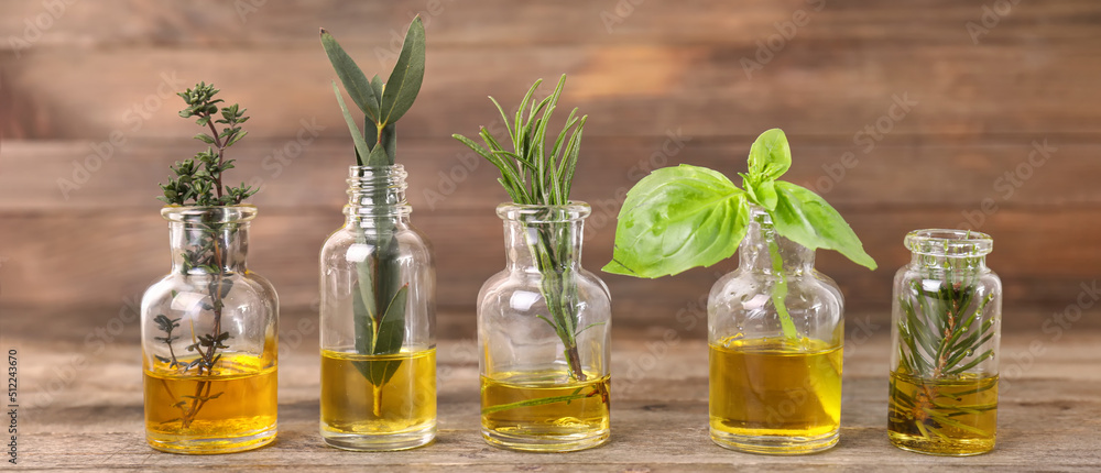 Bottles of different essential oils on wooden background Bottles of different essential oils on wooden background