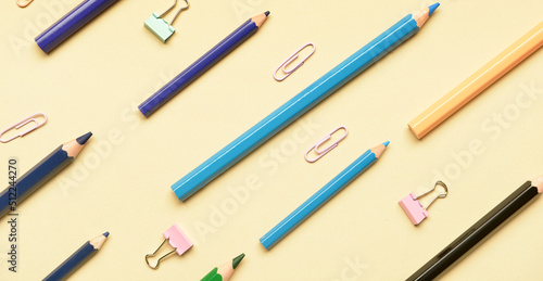 Different school supplies on color background, top view
