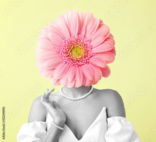 Woman with gerbera flower instead of her head on yellow background