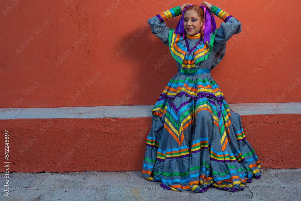 Young Mexican woman prepares her dress and makeup for a traditional Mexican dance