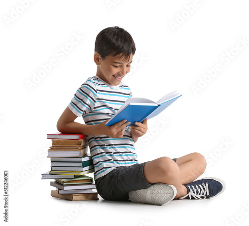 Cute little boy reading int...