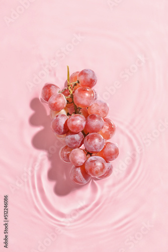 Tasty grapes in water on co...