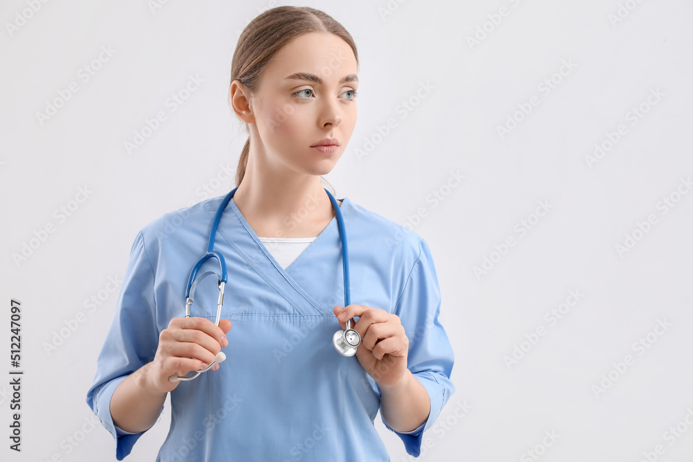 Female nurse with stethoscope on light background Female nurse with stethoscope on light background