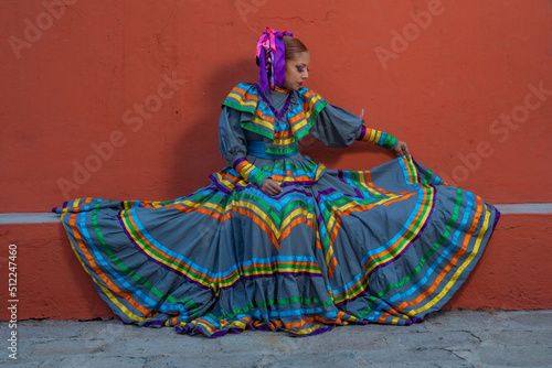 Portrait of a Mexican woman wearing a traditional dress for folk dance