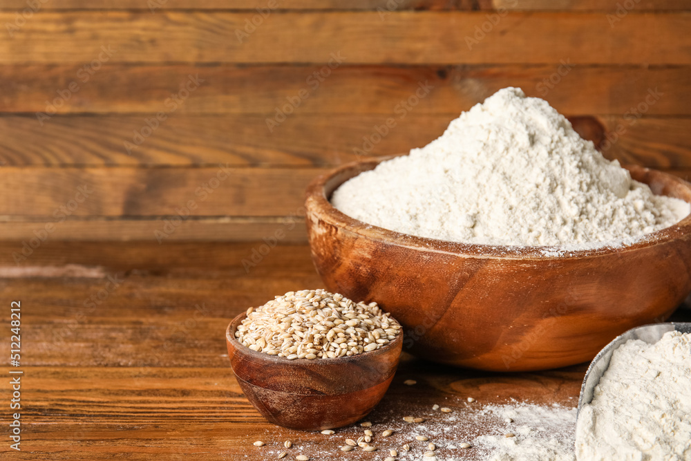 Scoop and bowls with wheat flour on wooden background Scoop and bowls with wheat flour on wooden background