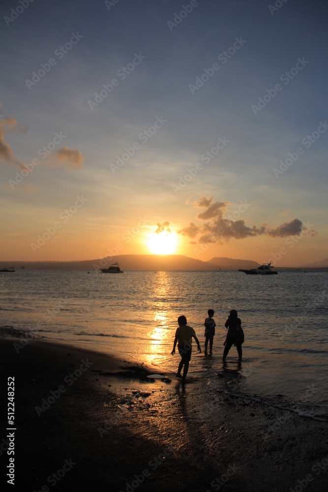 Beautiful view of sunrise on the beach with silhouettes people on the waterfront. Great for Background. Beautiful view of sunrise on the beach with silhouettes people on the waterfront. Great for Background.