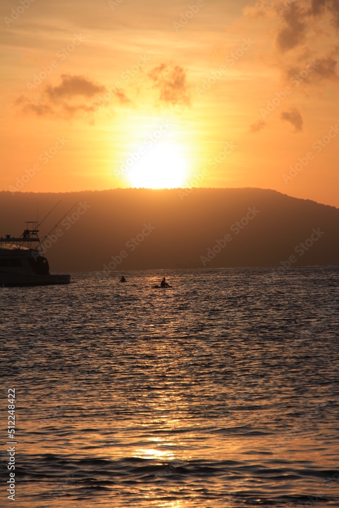 Beautiful view of sunrise on the beach with silhouettes people on the waterfront. Great for Background. Beautiful view of sunrise on the beach with silhouettes people on the waterfront. Great for Background.
