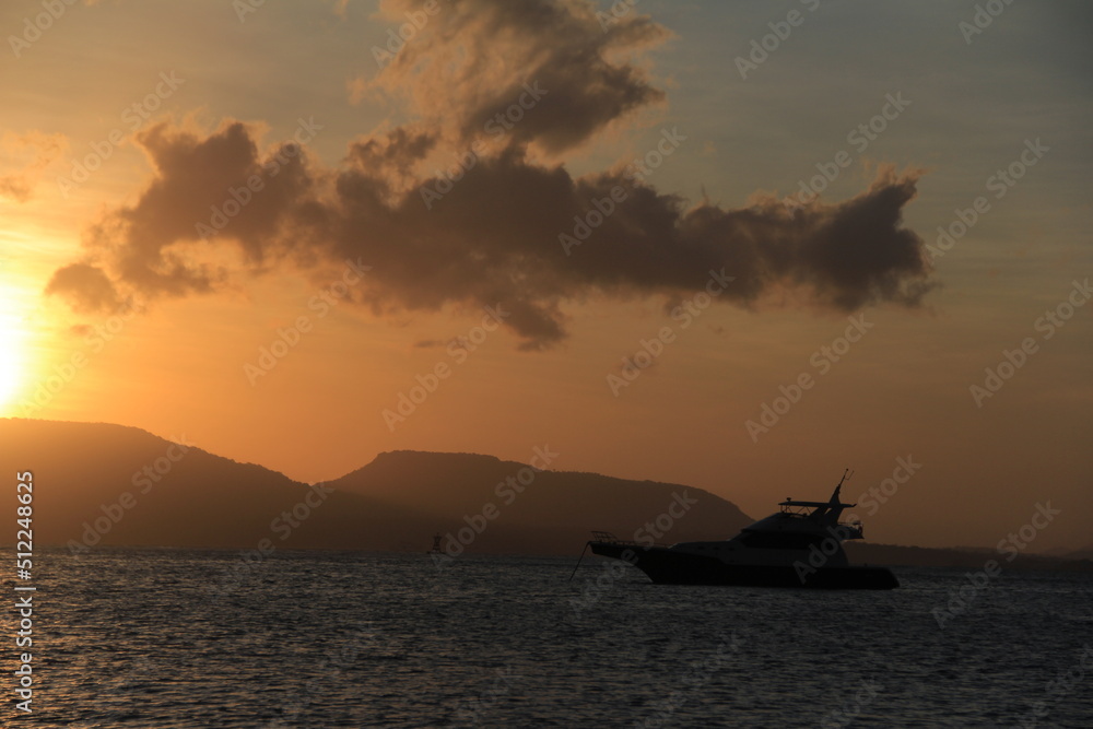 Beautiful view of sunrise on the beach with silhouettes people on the waterfront. Great for Background. 