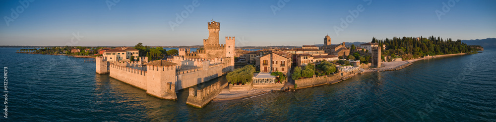 Panorama Sirmione aerial view of Lake Garda, Italy. View of Scaligero Castle at sunrise. Historic castle on the water on Lake Garda in Italy.