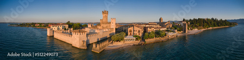 Panorama Sirmione aerial view of Lake Garda, Italy. View of Scaligero Castle at sunrise. Historic castle on the water on Lake Garda in Italy.
