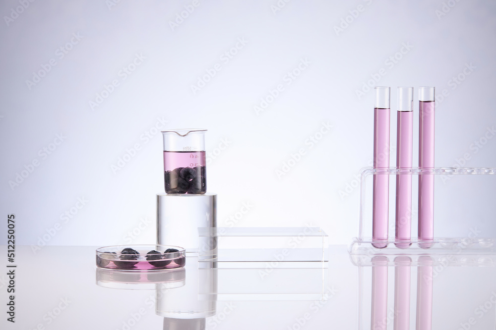 Front view of blueberry extract decorated with transparent podium and glassware blank space in white background Front view of blueberry extract decorated with transparent podium and glassware blank space in white background