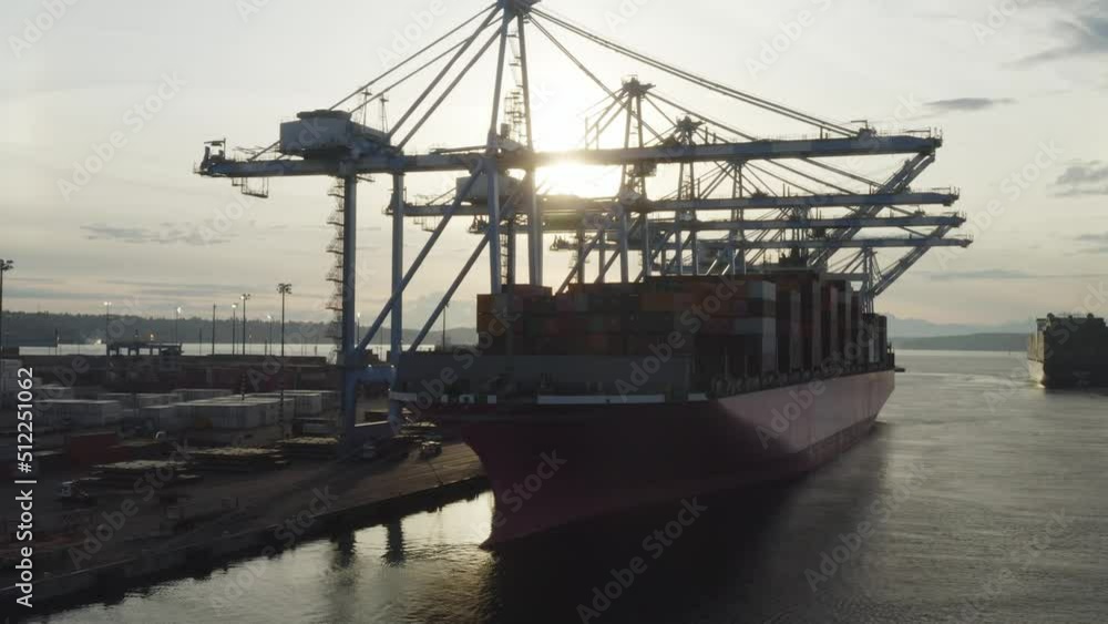 Huge Container Ship Docked During Sunset On Husky Terminal In Tacoma, Washington. Aerial Drone Shot Huge Container Ship Docked During Sunset On Husky Terminal In Tacoma, Washington. Aerial Drone Shot