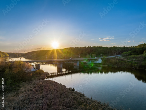 Beautiful view of the bridge across the Iset river in the city of Kamensk-Uralsky at sunset in spring. Kamensk-Uralskiy  Sverdlovsk region  Ural mountains  Russia.