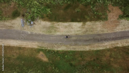 Tracking Shot Of People Cycling In Quite Place Middle Of Beautiful Green Landscape, California photo