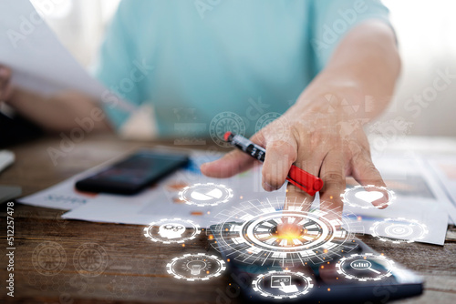 Businessman holding piggy bank documents on table with calculator icons related to investment finance.